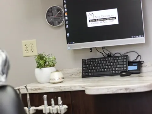 A treatment-room workstation at McNeil Dental, with the practice logo on the monitor.
